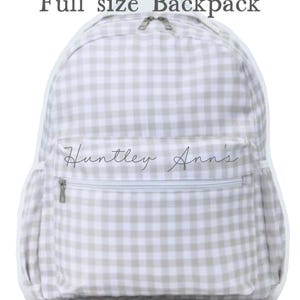 May include: A full-size backpack with a light gray and white gingham pattern. The backpack has a front zippered pocket and side pockets. The text "Full size Backpack" is at the top, and the text "Huntley Ann's" is on the front pocket.