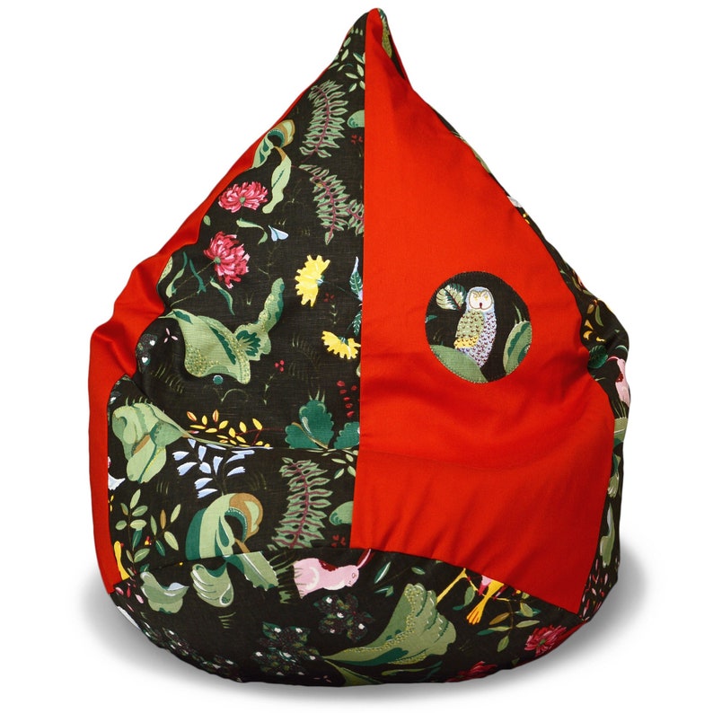 May include: A red and green beanbag chair with a whimsical owl design. The chair is made of fabric and has a round shape.