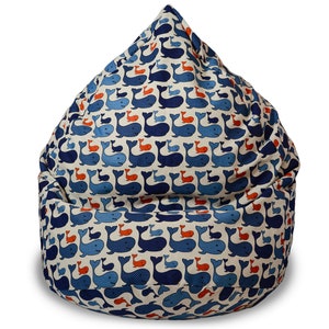 The Scandinavian-style bean bag chair is made from natural linen fabric with a lovely blue whale print. The beanbag shape is like a teardrop. It looks cozy and soft and invites you to sit.