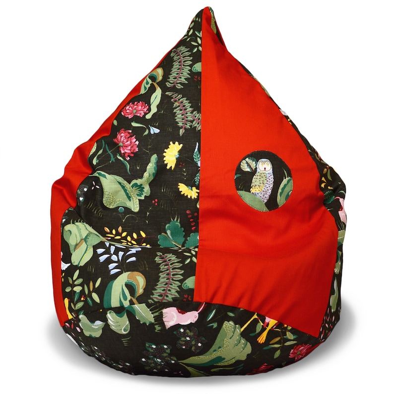 May include: A red and green beanbag chair with a whimsical owl design. The chair is made of fabric and has a round shape.