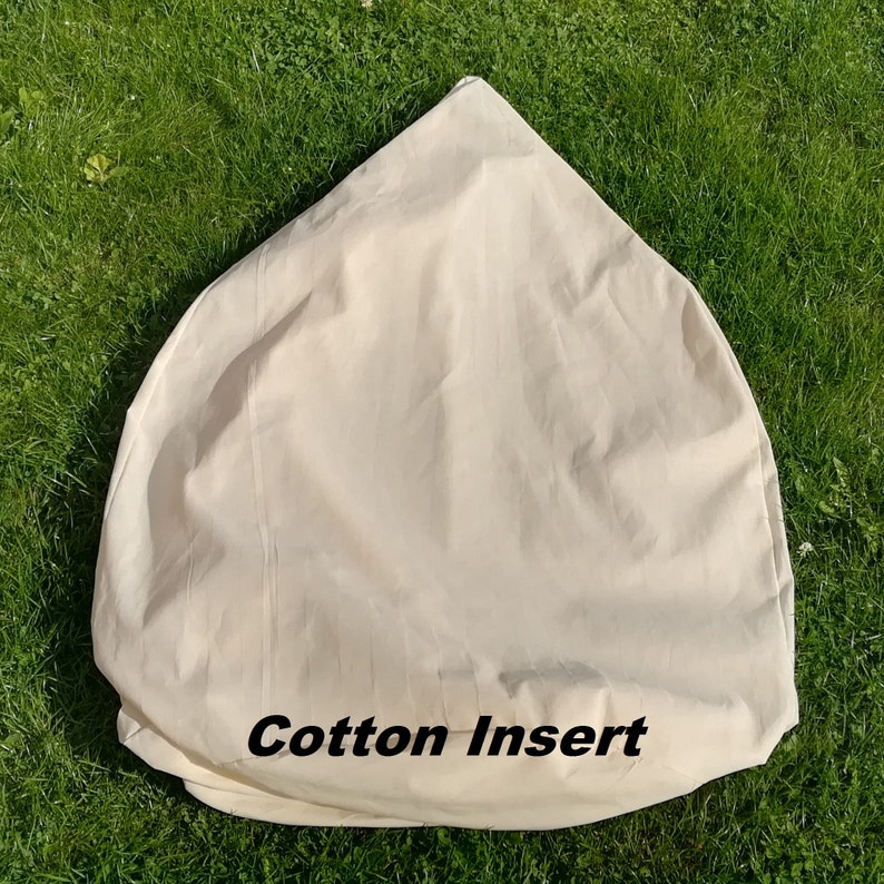 May include: A white cotton insert for a bean bag chair. The insert is shaped like a cone and has the words "Cotton Insert" printed on the bottom.