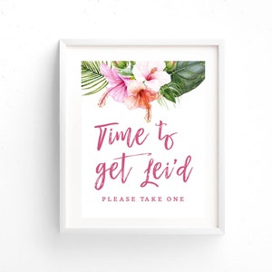 May include: A white framed sign with pink tropical flowers and green leaves. The sign says "Time to get Lei'd" and "Please take one".