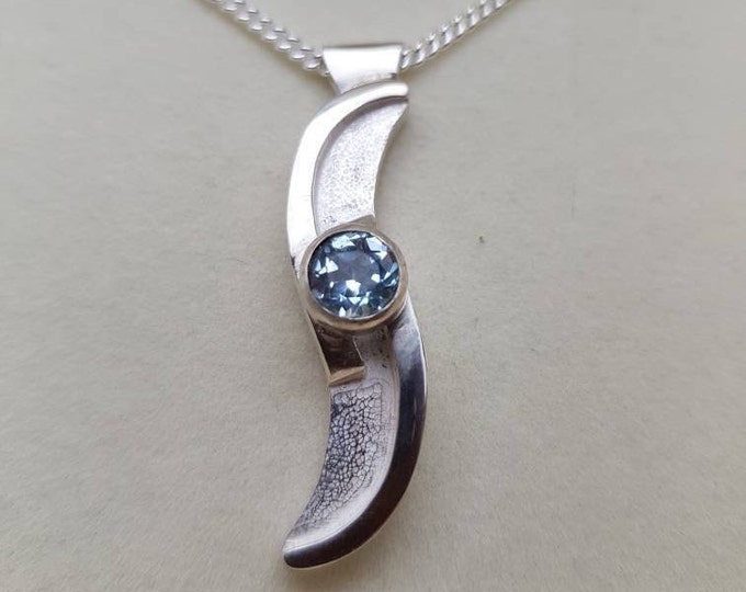 Stunning Sterling Silver Wave Pendant With Bezel Set Pale Blue Topaz.