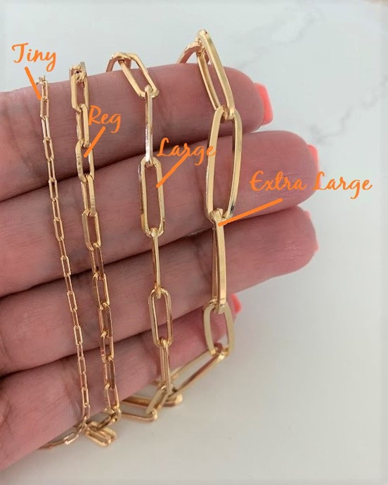 May include: Four gold chain necklaces of different sizes, labeled "Tiny", "Reg", "Large", and "Extra Large".