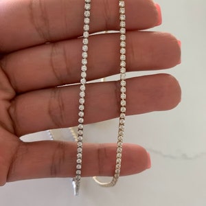 May include: Two gold chains with small diamonds set in a tennis chain style.