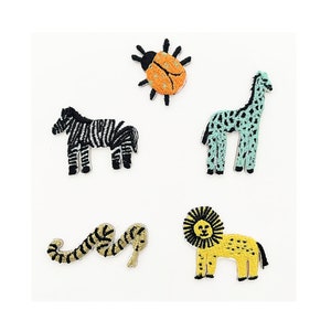 May include: Embroidered patches featuring a zebra with black and white stripes, a ladybug with orange and black details, a giraffe with blue and black spots, a yellow lion with a black mane, and a snake with gold and black stripes.