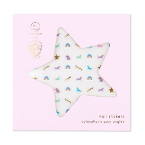 May include: A sheet of white star-shaped nail stickers with a unicorn, rainbow, and shooting star design. The stickers are packaged on a pink card with the text "nail stickers" and "autocollants pour ongles".