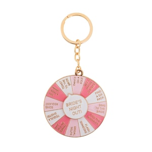 May include: A gold-colored metal keychain with a circular charm. The charm features a pink and white wheel with phrases like "Bride's Night Out!", "Dance on a Pole", and "Find a Six Pack".