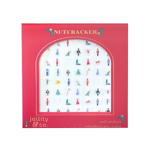 May include: A red box of nail stickers with a Nutcracker theme. The stickers feature various festive designs, including soldiers, Christmas trees, and candy canes. The brand name "jollity & co." is printed on the box, along with the words "nail stickers" and "autocollants pour ongles".