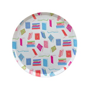 May include: White round paper plate with a colorful pattern of stacked books. The books are in various colors, including pink, blue, green, and red. The plate is perfect for a book-themed party.