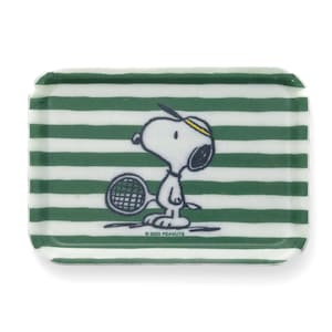 May include: A green and white striped tray with a cartoon image of Snoopy playing tennis. The tray has the text "© 2023 PEANUTS" printed on the bottom.