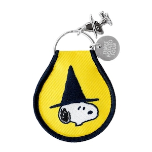 May include: A yellow teardrop-shaped embroidered patch keychain with a dark blue border. The patch features a white cartoon dog wearing a dark blue pointed hat. A silver metal ring holds a small silver charm with the text THREE POTATO FOUR.