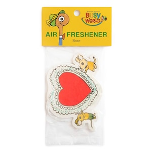 May include: A packaged air freshener with a red heart design, lace trim, and cartoon dogs. The yellow packaging reads "AIR FRESHENER" and "Rose", with "Richard Scarry's Busy World" branding. The product is in a clear plastic bag.