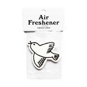May include: A white air freshener in a clear plastic package. The air freshener is shaped like a bird with black outline details. The package has a white header with the words "Air Freshener" and "Fresh Linen".