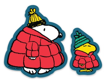 May include: Two die-cut stickers featuring Snoopy and Woodstock in winter attire. Snoopy is wearing a red puffer coat and yellow knit cap. Woodstock is in a red coat and green knit cap. Both are outlined in blue.