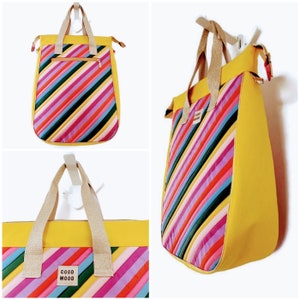 May include: Yellow tote bag with diagonal rainbow stripes and a brown leather patch that says "Good Mood".