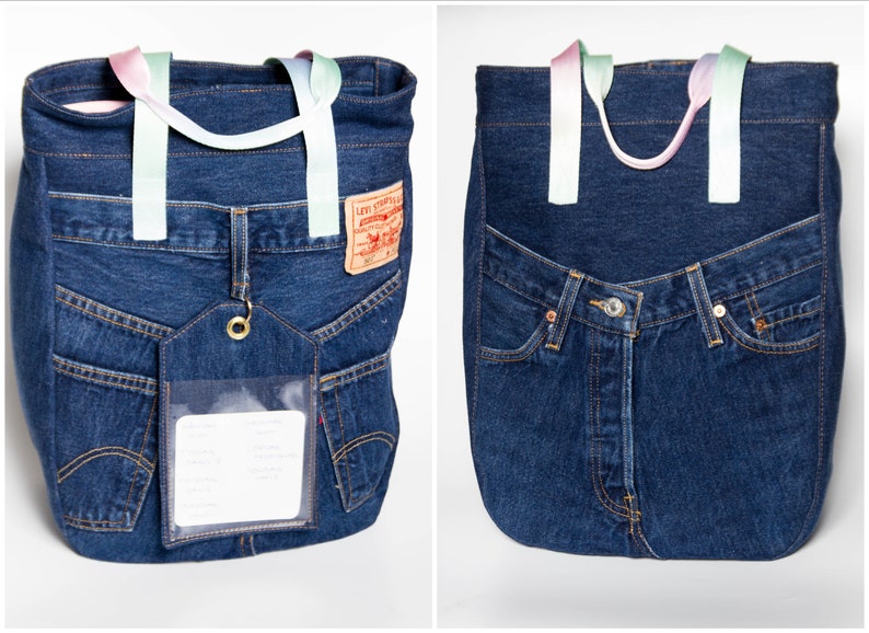 May include: A blue denim tote bag with a clear plastic pocket and a Levi's label. The bag has two rainbow-coloured straps.
