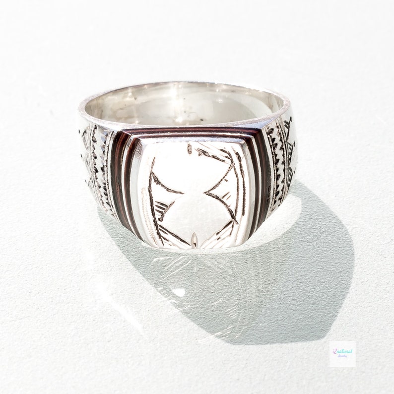 Tuareg ethnic silver ring with carved tribal wood inlaid.