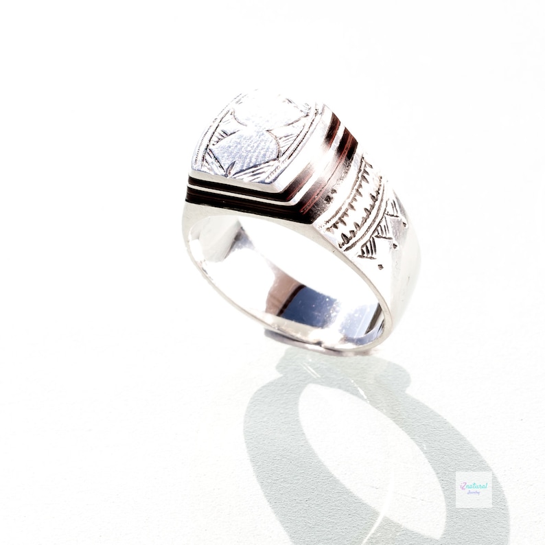 Tuareg ethnic silver ring with carved tribal wood inlaid.