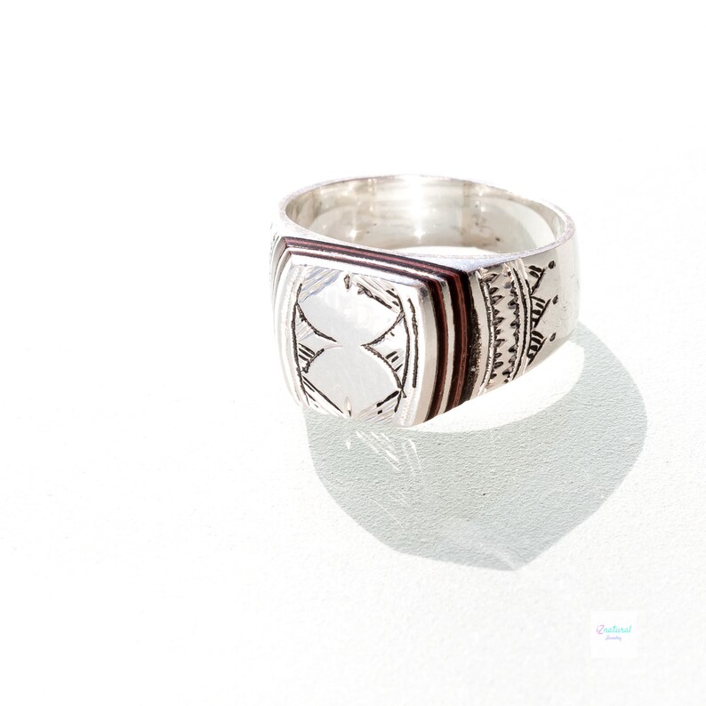 Tuareg ethnic silver ring with carved tribal wood inlaid.