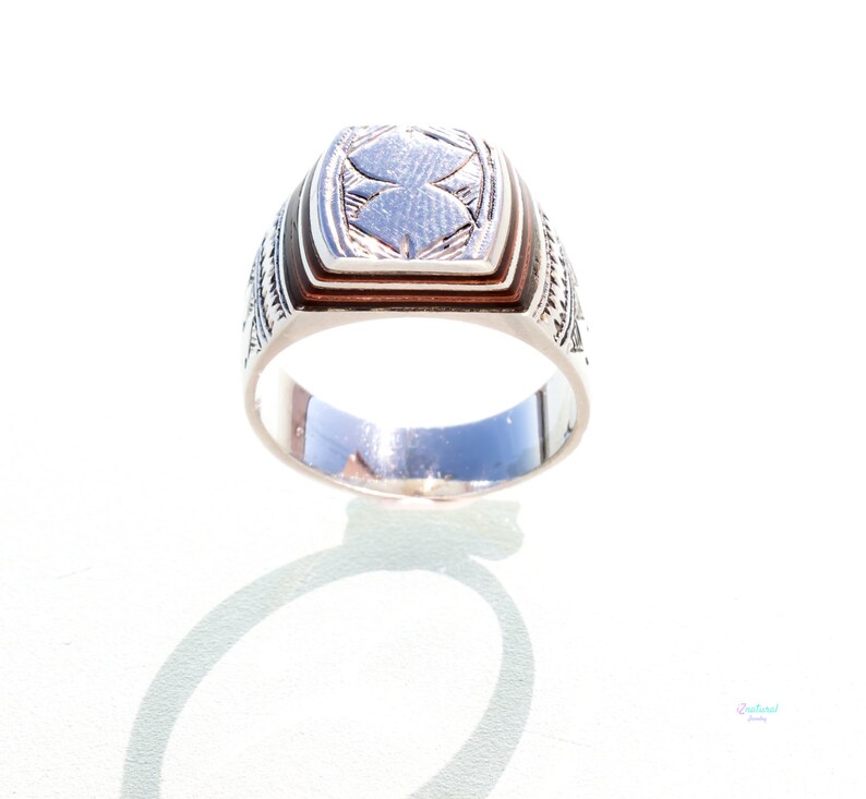 Tuareg ethnic silver ring with carved tribal wood inlaid.