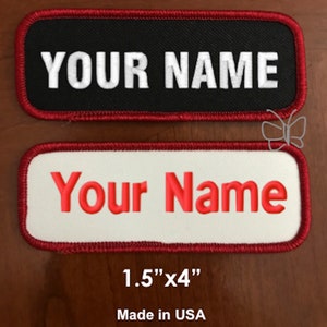 May include: Two rectangular embroidered patches with red stitching. The top patch is black with white text that reads "YOUR NAME". The bottom patch is white with red text that reads "Your Name". The patches are 1.5 inches by 4 inches and made in the USA.