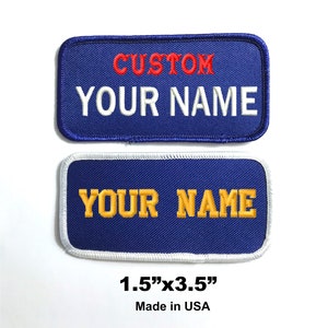 May include: Two blue embroidered patches with white stitching. The top patch has red text that says "CUSTOM" and white text that says "YOUR NAME". The bottom patch has yellow text that says "YOUR NAME". The patches are 1.5 inches by 3.5 inches and made in the USA.