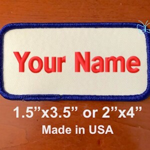 May include: White fabric patch with a blue border and red embroidered text that says "Your Name". The patch is available in two sizes: 1.5" x 3.5" or 2" x 4". Made in the USA.