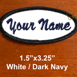 May include: Oval-shaped patch with the text "Your Name" embroidered in dark navy blue on a white background. The patch is bordered with a black stitched edge and measures 1.5" x 3.25".