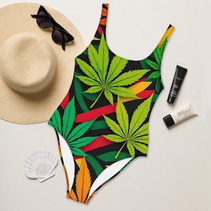 May include: A black one-piece swimsuit with a green, red, and yellow marijuana leaf pattern.