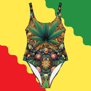 May include: One-piece swimsuit with a vibrant, detailed cannabis leaf design. The swimsuit features a scoop neck and a low back. The design incorporates various elements in shades of green, gold, and blue, set against a white background.