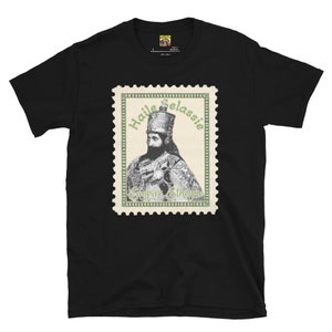 May include: Black t-shirt with a green and white stamp design featuring a portrait of Haile Selassie, Emperor of Ethiopia.