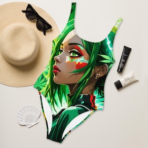 May include: A white swimsuit with a green, black, and red graphic print of a woman with green hair. The woman's face is painted with green, red, and white makeup.