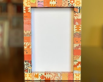 Decorative orange picture frame, striped, collaged with vintage and recycled papers