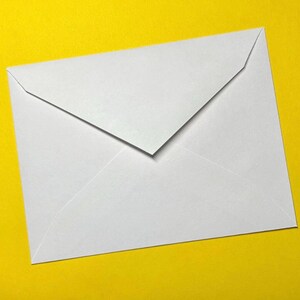 May include: A white envelope with a triangular flap, set against a bright yellow background. The envelope is rectangular with a folded top, creating a clean, minimalist design. The paper appears smooth and opaque.