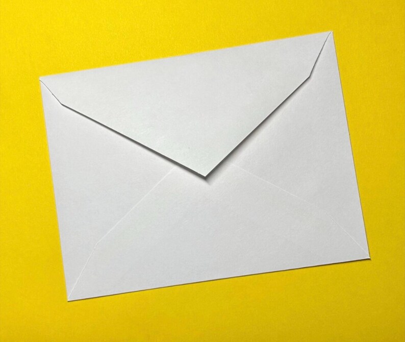 May include: A white envelope with a triangular flap, set against a bright yellow background. The envelope is rectangular with a folded top, creating a clean, minimalist design. The paper appears smooth and opaque.