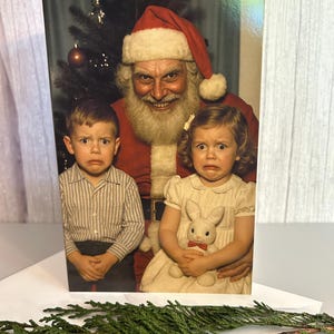 May include: A greeting card featuring a vintage photograph of Santa Claus with two children. The children have distressed expressions. Santa is wearing a red suit and hat. The girl is holding a stuffed bunny. A Christmas tree is in the background.