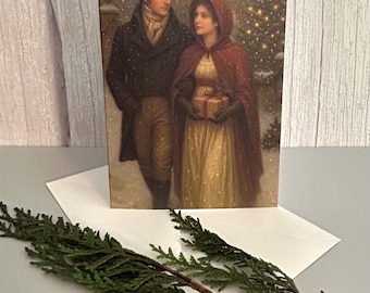 May include: A rectangular greeting card featuring a historical illustration of two figures in winter attire walking through snow. One figure wears a black top hat and coat, while the other wears a red hooded cloak and holds a small wrapped gift.