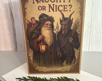 May include: A rectangular greeting card with the text Naughty or Nice? featuring an illustration of a bearded figure in a green cloak holding a lantern and a horned, dark-furred creature holding a bundle of sticks and a chain.