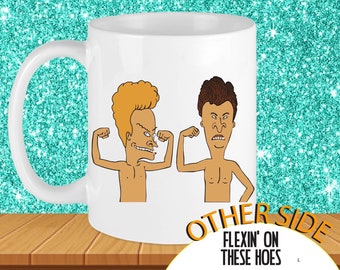 May include: White ceramic mug with a cartoon image of two men flexing their muscles. The text "OTHER SIDE FLEXIN' ON THESE HOES" is printed on the bottom of the mug.