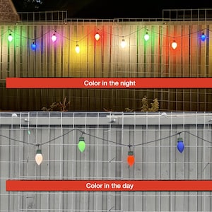 May include: A string of multi-colored LED light bulbs hanging on a wire against a fence. The top section shows the bulbs illuminated at night in red, green, blue, purple, orange, white, and yellow. The bottom section shows the bulbs in daylight.