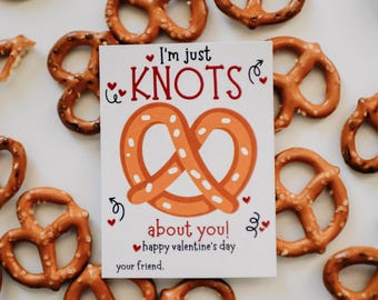 May include: A Valentine's Day card with a pretzel illustration and the text "I'm just knots about you! Happy Valentine's Day your friend."