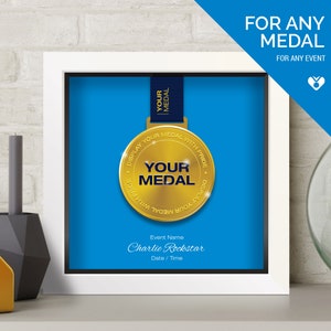 May include: A square white shadow box frame containing a gold medal on a dark blue ribbon against a bright blue background. The medal features the text "YOUR MEDAL" and "DISPLAY YOUR MEDAL WITH PRIDE". Below, the text reads "Event Name", "Charlie Rockstar", and "Date / Time".