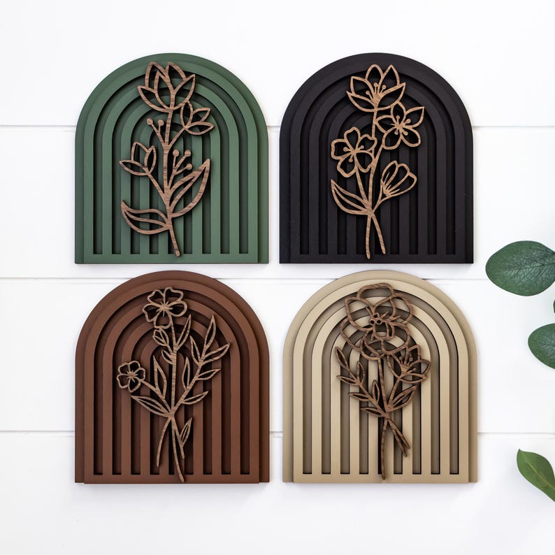May include: Four wooden wall decor pieces featuring a floral design with a rainbow arch background. The arches are in shades of green, black, brown, and beige.
