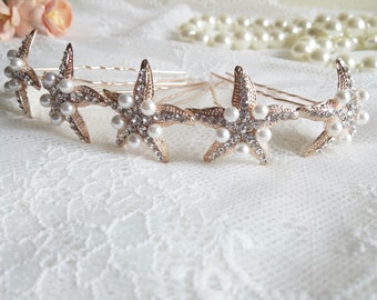 May include: Set of four gold starfish hair clips with pearl and rhinestone accents.
