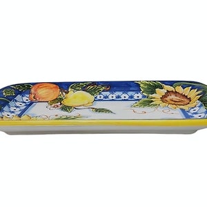 May include: Rectangular ceramic serving platter with a hand-painted design. The platter features a blue border with fruit and sunflower motifs. The rim is yellow, and the center is white.