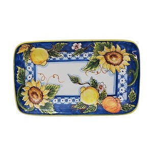 May include: Rectangular ceramic serving platter with a blue border and a white center. The platter is decorated with sunflowers, lemons, and peaches. The border has a blue and white pattern with a yellow edge.