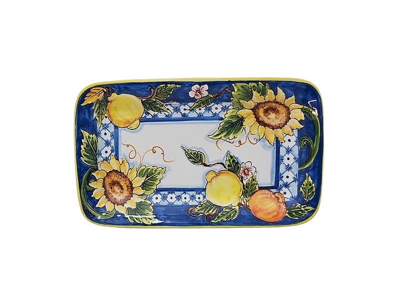 May include: Rectangular ceramic serving platter with a blue border and a white center. The platter is decorated with sunflowers, lemons, and peaches. The border has a blue and white pattern with a yellow edge.