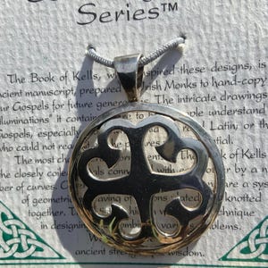May include: A silver Celtic knot pendant necklace with a Celtic knot design. The pendant is on a white card with the text "Celtic Highland Series" and a description of the Celtic knot.