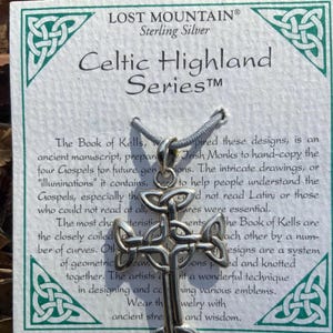 May include: Sterling silver Celtic knot pendant necklace inspired by the Book of Kells. The pendant features a Celtic cross design with intricate knotwork. The necklace is part of the Celtic Highland Series.